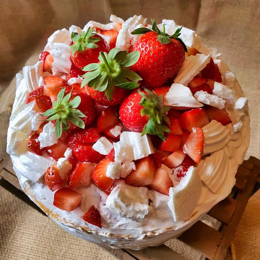 Luxury cake topped with fresh strawberries and and meringue